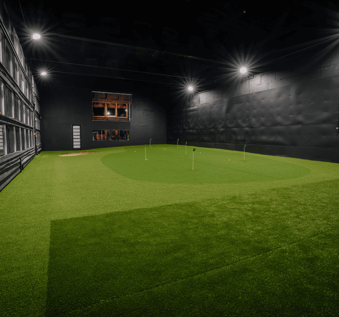 Artificial grass indoor golf practice area.