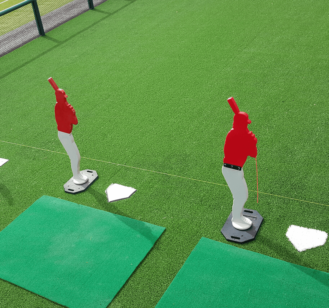 Baseball practice mannequins on green field
