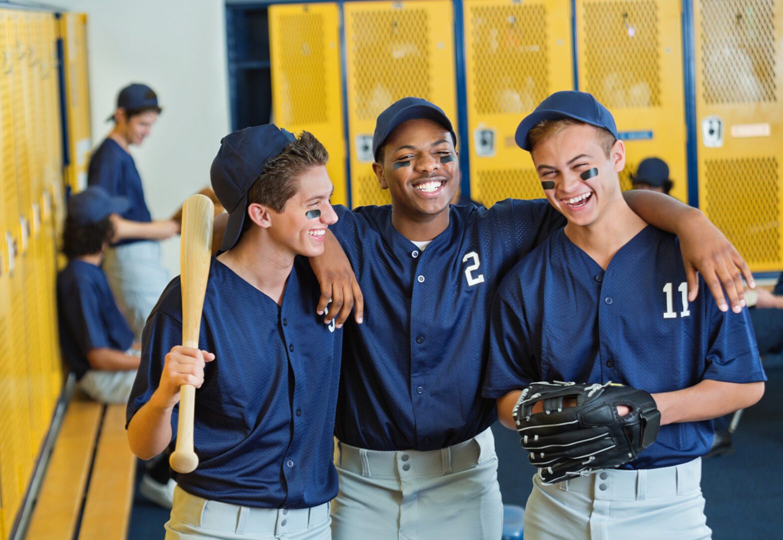Friends in baseball uniforms with equipment